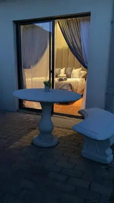 a table in front of a room with a bed at OR Tambo Stay Unit 2 in Boksburg