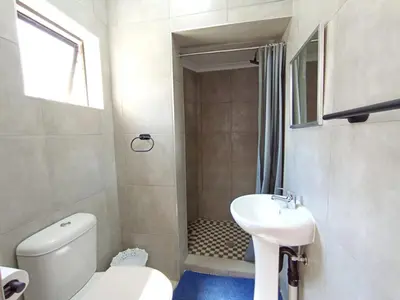 a small bathroom with a toilet and a sink at OR Tambo Stay Unit 2 in Boksburg