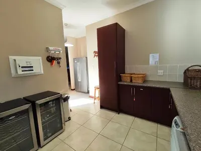 a kitchen with a counter and a refrigerator at Rawlingsons Country House in Dullstroom