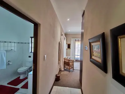 a bathroom with a toilet and a sink at Rawlingsons Country House in Dullstroom