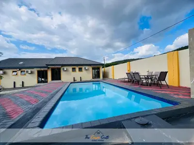 a swimming pool in the backyard of a house at The Curve Suite Guest House in Nkowakowa