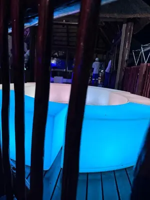 a bath tub with blue lighting in a room at Falcon Lodge Bela Bela in Bela-Bela