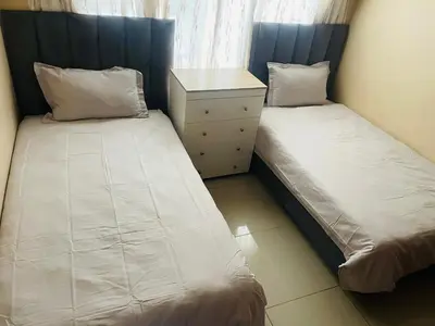 two beds sitting next to each other in a room at Bela Waterfront Villa in Bela-Bela