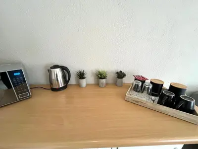 a counter top with a coffee maker and some plants at OR Tambo Stay Unit 1 in Boksburg