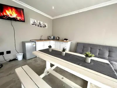 a living room with a table and a couch at OR Tambo Stay Unit 1 in Boksburg