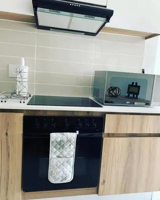 a kitchen with a black stove with a towel on it at Luxury Holiday Homes - The Blyde in Pretoria