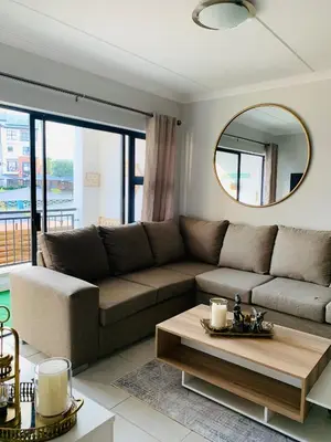 a living room with a couch and a table at Luxury Holiday Homes - The Blyde in Pretoria