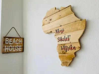 a wooden sign hanging on a wall with the words on it at Luxury Holiday Homes - The Blyde in Pretoria