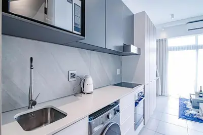 a kitchen with a sink and a washing machine at Menlyn Maine Luxury Apartments 11th & 14th floor with Balcony in Pretoria