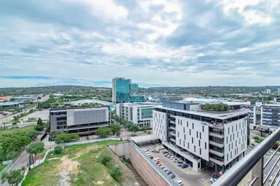 an aerial view of a city with tall buildings at Menlyn Maine Luxury Apartments 11th & 14th floor with Balcony in Pretoria