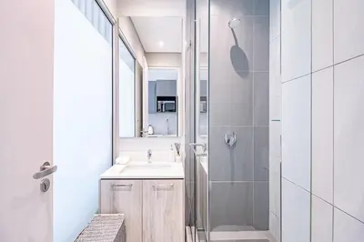 a bathroom with a sink and a shower at Menlyn Maine Luxury Apartments 11th & 14th floor with Balcony in Pretoria