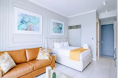 a living room with a bed and a couch at Menlyn Maine Luxury Apartments 11th & 14th floor with Balcony in Pretoria