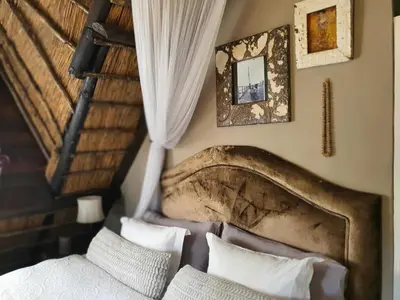 a bedroom with a bed with a large headboard at Waterhouse Guest Lodge in Waterkloof in Pretoria