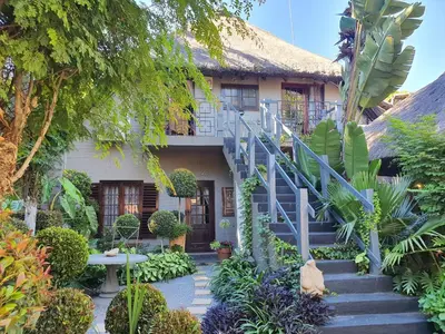 a house with a staircase in front of it at Waterhouse Guest Lodge in Waterkloof in Pretoria