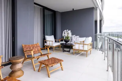 a balcony with chairs and a table on a building at The Cassini Diamond @ Ellipse Waterfall in Midrand