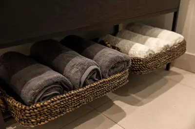 two baskets of towels on a shelf in a bathroom at The Cassini Diamond @ Ellipse Waterfall in Midrand
