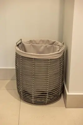 a wicker basket sitting in the corner of a room at The Cassini Diamond @ Ellipse Waterfall in Midrand