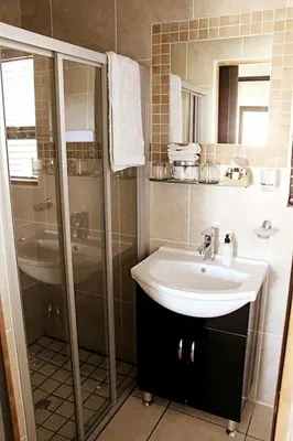 a bathroom with a sink and a shower at Casa Flora Guesthouse in Pretoria