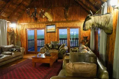 a living room with couches and a horse head on the wall at Lucca Lodge in Musina