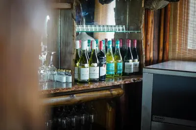 a bunch of bottles of wine on a shelf at Lucca Lodge in Musina