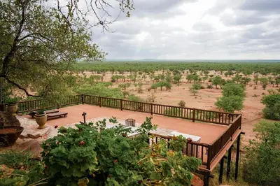 a wooden deck with a view of a field at Lucca Lodge in Musina