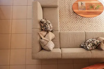 a couch with pillows on it in a room at Villa Fika Futi in Hoedspruit