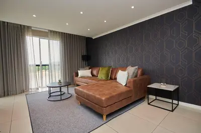 a living room with a couch and a table at Unit 404 at Menlyn Place in Pretoria