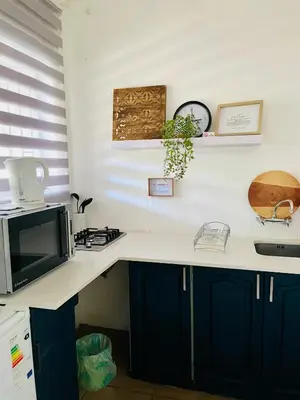 a kitchen with a counter top with a microwave at Tjimaka Farm in Hazyview