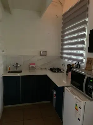 a kitchen with a sink and a microwave at Tjimaka Farm in Hazyview