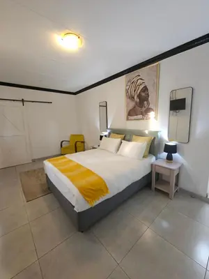 a bedroom with a large bed and a tv at 43 Home apartment in Del Judor