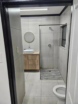 a bathroom with a shower and a sink and a toilet at 43 Home apartment in Del Judor