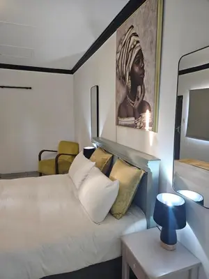 a bedroom with a bed and a painting on the wall at 43 Home apartment in Del Judor