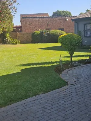 a brick pathway in a yard with a tree in the middle at 43 Home apartment in Del Judor