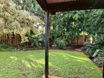 a yard with a fence and a pole in the grass at Baruch in Pretoria