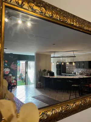 a mirror reflecting a kitchen and a dining room at Elizabeth the 7th in Tzaneen