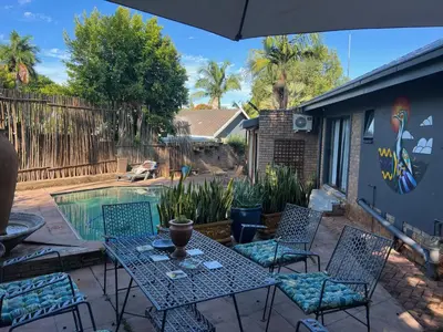 a patio with a table and chairs and a pool at Elizabeth the 7th in Tzaneen
