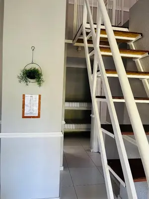 a staircase in a building with areath on the wall at Pendleberry Grove Unit 36 in Bela-Bela