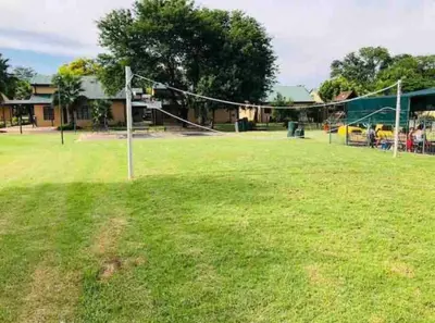 a volleyball court with a net in a field at Pendleberry Grove Unit 36 in Bela-Bela
