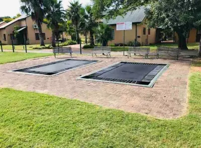a group of benches sitting in a park at Pendleberry Grove Unit 36 in Bela-Bela