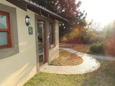 a walkway next to a building with a window at Strawberry Fields Country Manor Guest House in Johannesburg