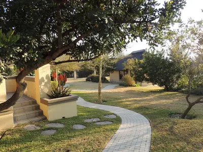 a walkway in a yard next to a house at Strawberry Fields Country Manor Guest House in Johannesburg