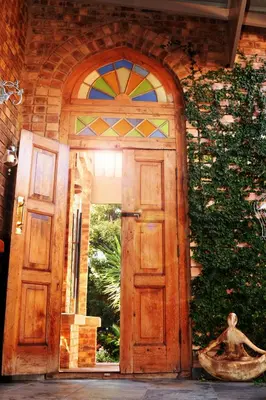 a wooden door with a stained glass window at Pumpkin Tree Guesthouse in Middelburg