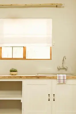 a kitchen counter with a sink and a mirror at Pumpkin Tree Guesthouse in Middelburg