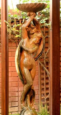 a statue of a woman carrying a bowl on her head at The Woodpecker Inn in Pretoria