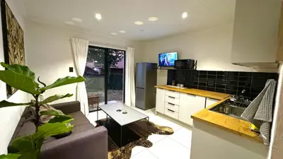 a kitchen with a couch and a table in a room at Micro Urban Oasis 2 in Pretoria