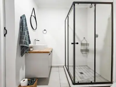 a bathroom with a shower and a sink at Micro Urban Oasis 2 in Pretoria