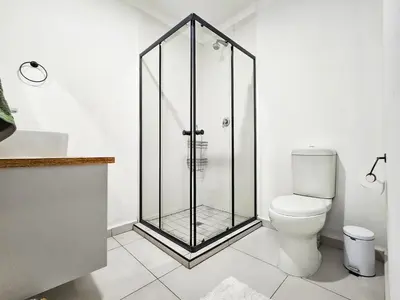 a shower stall in a bathroom with a toilet at Micro Urban Oasis 2 in Pretoria