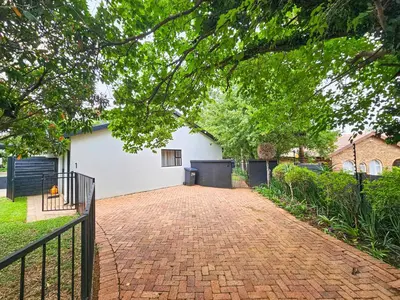 a brick driveway in front of a white house at Micro Urban Oasis 2 in Pretoria
