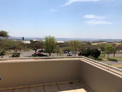 a balcony with a view of a parking lot at Golf Suites @ Copperleaf in Centurion