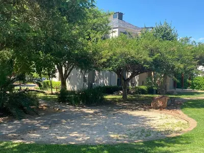 a house with trees in the front yard at Golf Suites @ Copperleaf in Centurion
